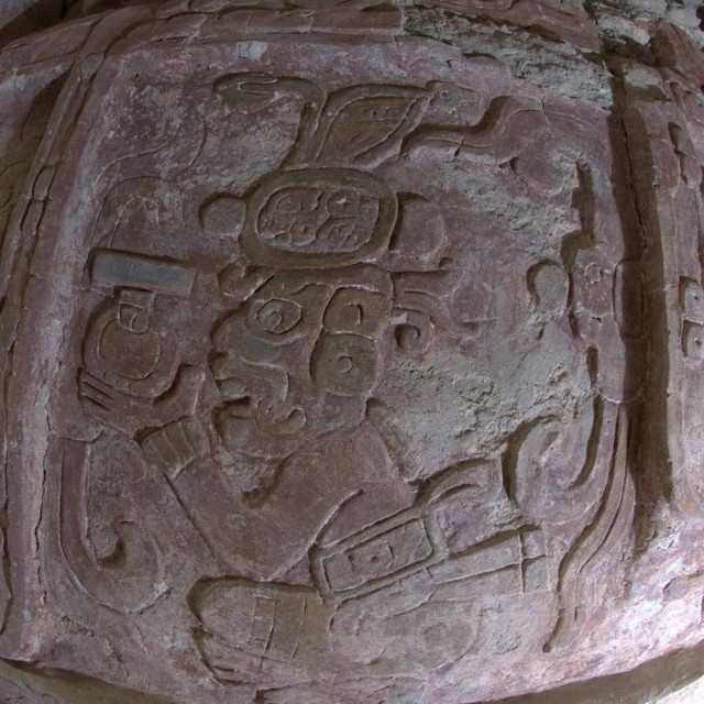 A figure offering the first tamal to the gods
