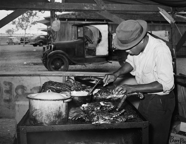 Man barbecueing (historic image)